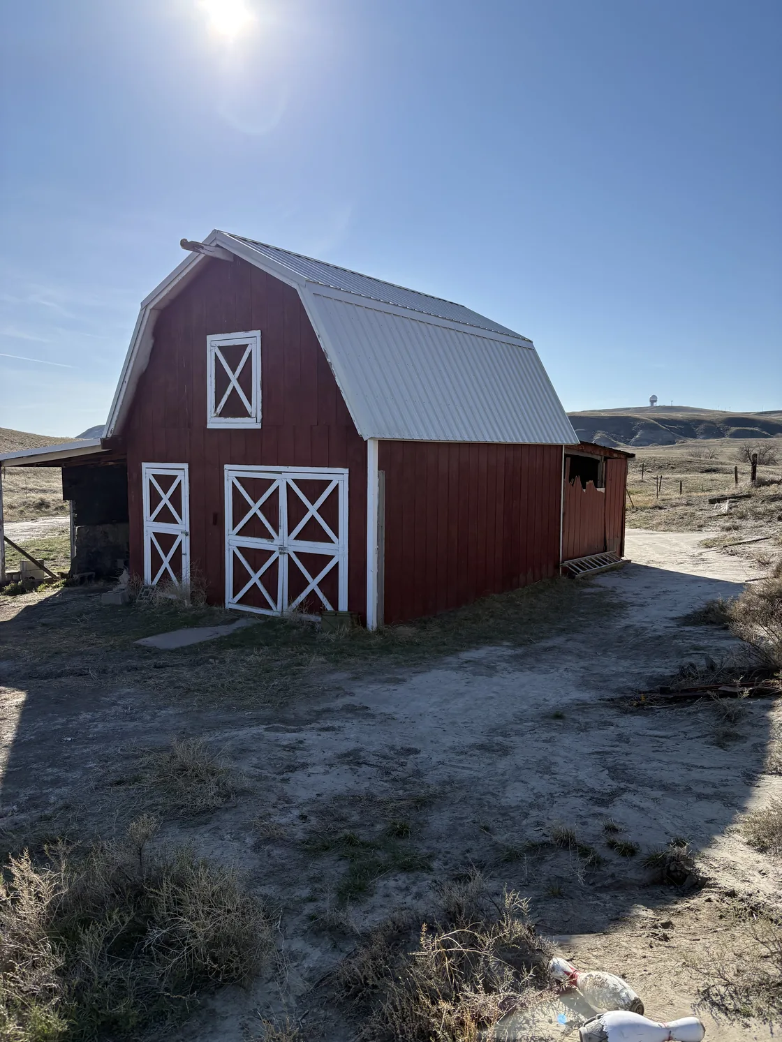 Great Falls red barn with the completed Tough Rib steel roof installed.