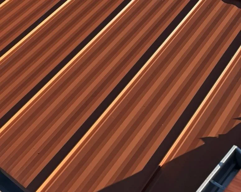 Close-up of copper-colored snap-lock steel panels on a Great Falls roof replacement.