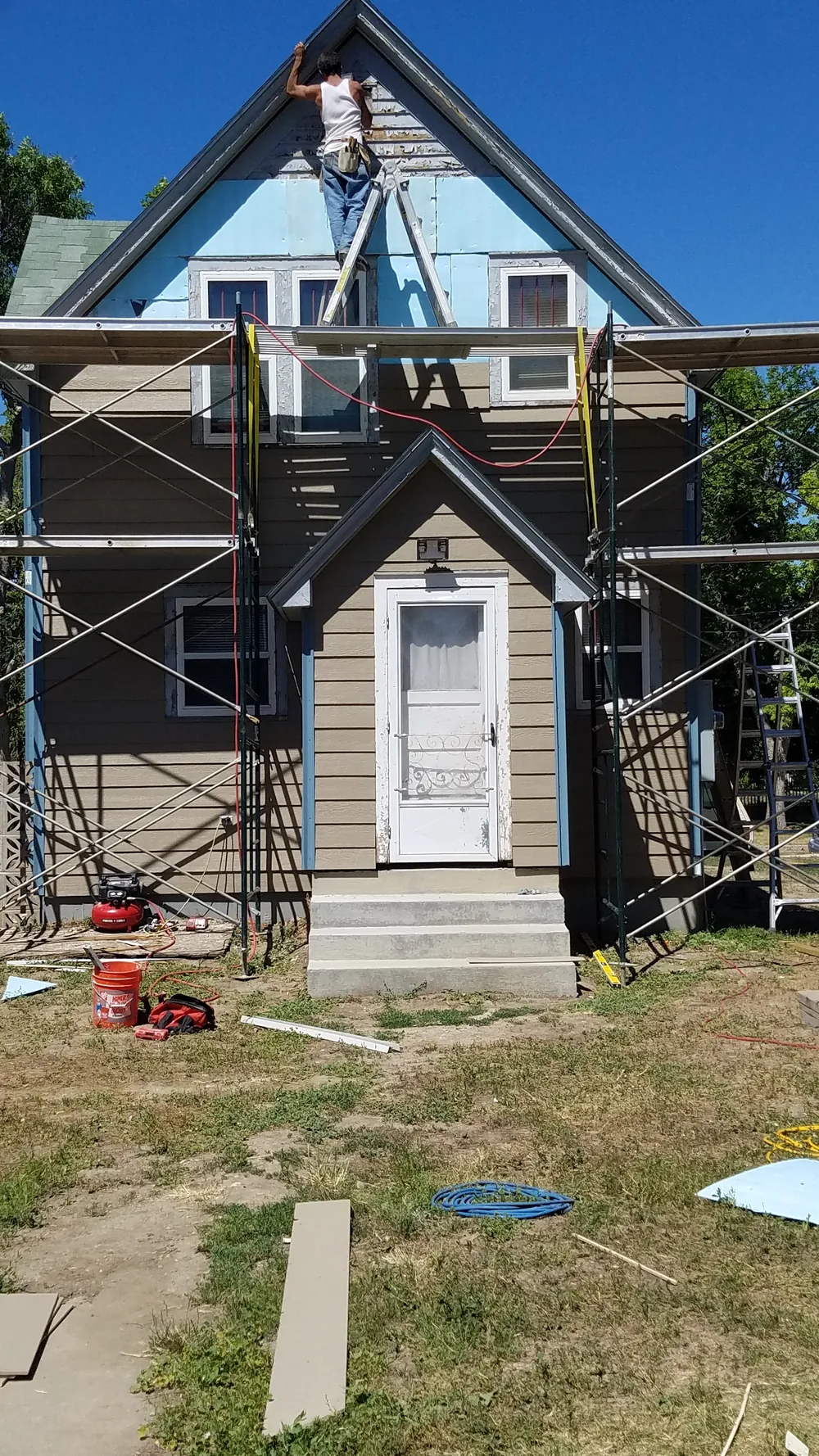 Accent Renovations exterior siding project in progress with scaffolding at the house.